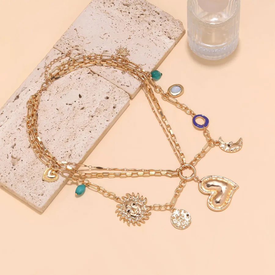 Elevate Your Style with the Handmade Multi-Layered Heart Sun Moon Pendant Necklace