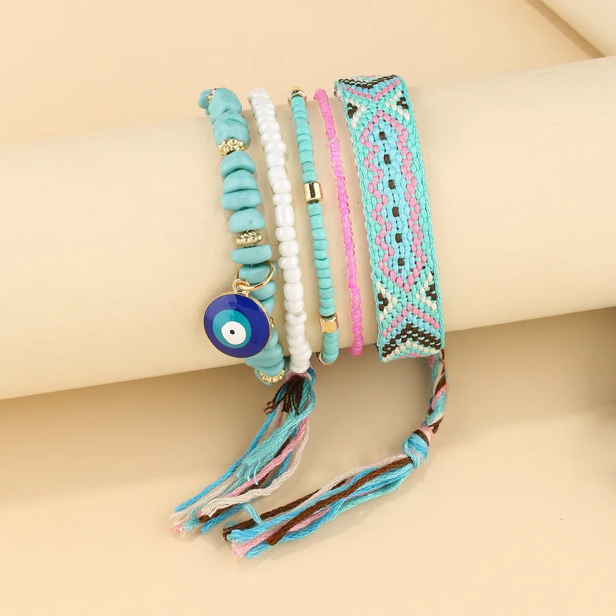 Discover the Elegance of the Handmade Woven Blue Eye Pendant Multi-Layer Beaded Bracelet